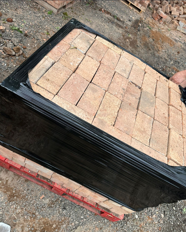 Weathered reclaimed imperial bricks stacked on pallets