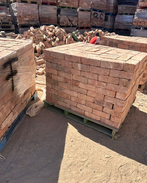 Stacked reclaimed wirecut red bricks